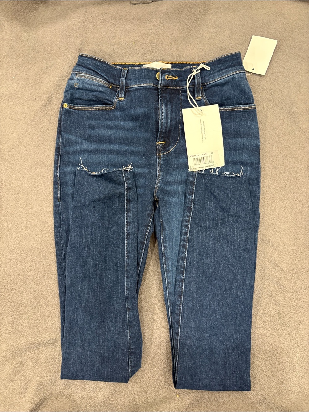 Frame Denim Mid-Rise Skinny Jeans in Dark Blue with Raw-Knee Detail